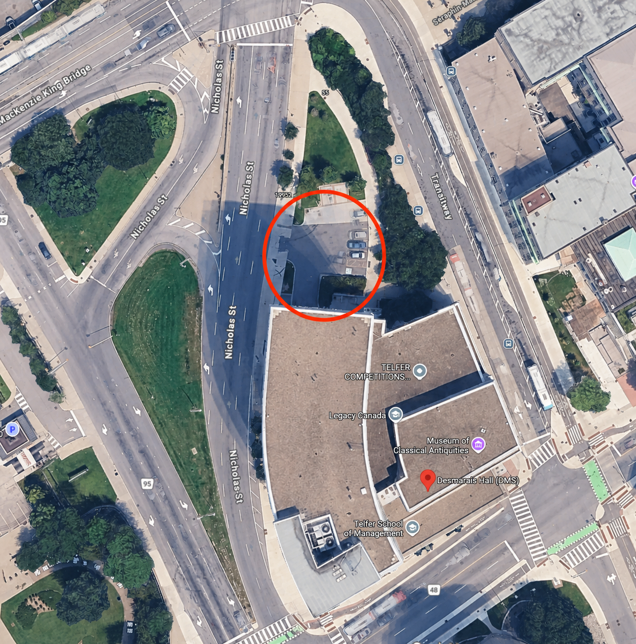 Satellite map showing the shuttle pickup parking lot beside the Desmarais Building circled in red
