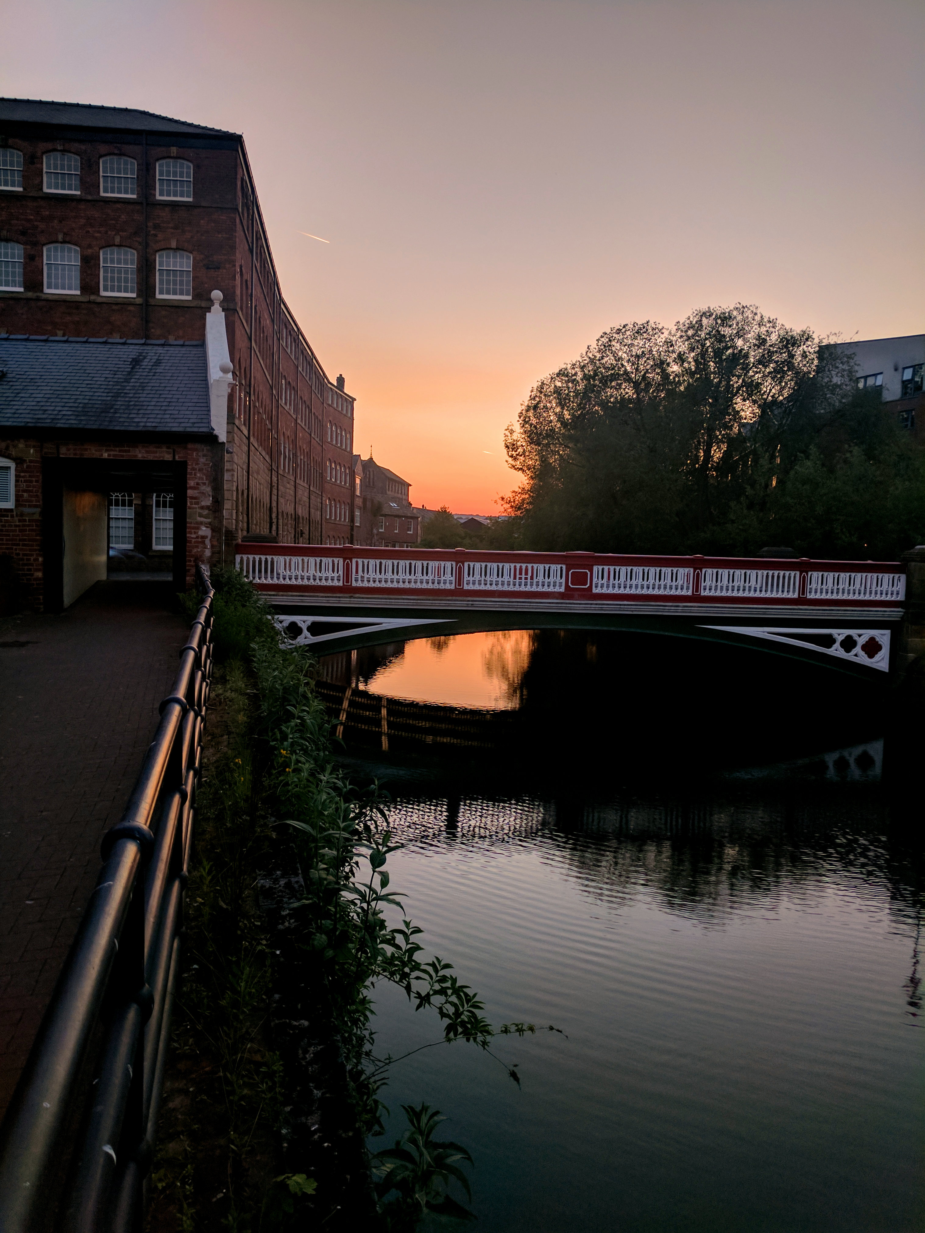 Kelham Island Quarter showing historic industrial bridge over River Don at sunset